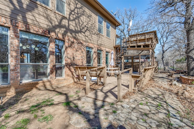 view of patio / terrace with a wooden deck and stairs