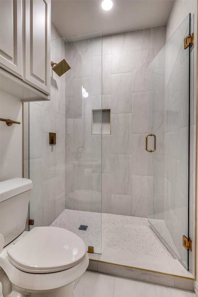 bathroom featuring recessed lighting, a stall shower, and toilet