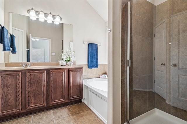 full bath with tile patterned floors, a garden tub, a stall shower, and vanity