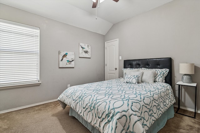 carpeted bedroom featuring lofted ceiling, baseboards, and ceiling fan