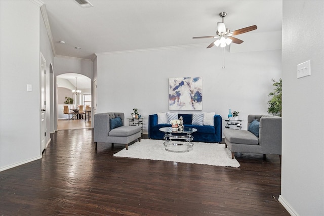 living area with a ceiling fan, wood finished floors, baseboards, arched walkways, and ornamental molding