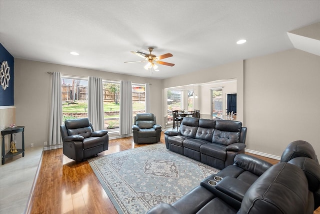 living area with recessed lighting, light wood-style floors, ceiling fan, and lofted ceiling