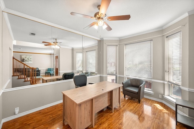 office space with wood finished floors, a ceiling fan, visible vents, and ornamental molding