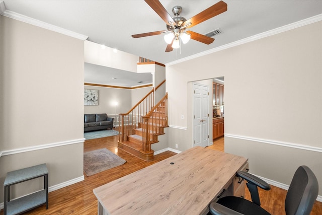 office area with visible vents, wood finished floors, crown molding, baseboards, and ceiling fan