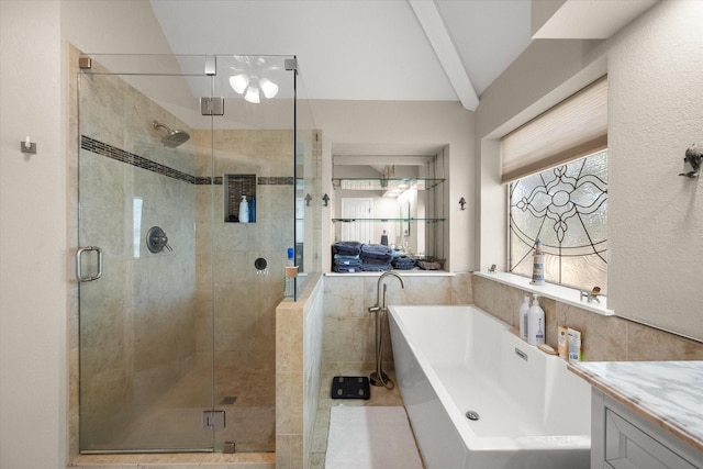 full bath featuring a freestanding tub, vanity, tile walls, and a shower stall