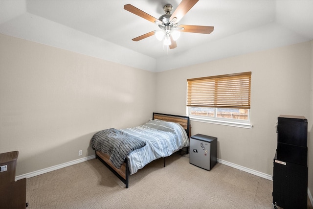 carpeted bedroom featuring ceiling fan, baseboards, and vaulted ceiling