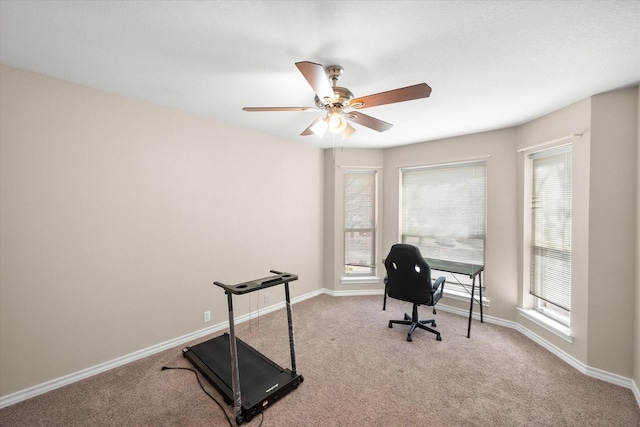 office area featuring baseboards, carpet floors, and a ceiling fan