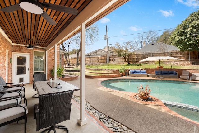 view of pool with an outdoor living space, a fenced backyard, a fenced in pool, and a patio