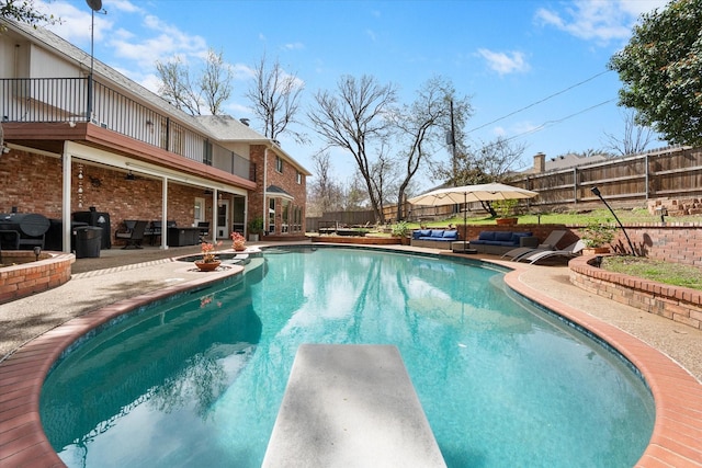 view of pool with a patio, a fenced in pool, area for grilling, a fenced backyard, and a diving board