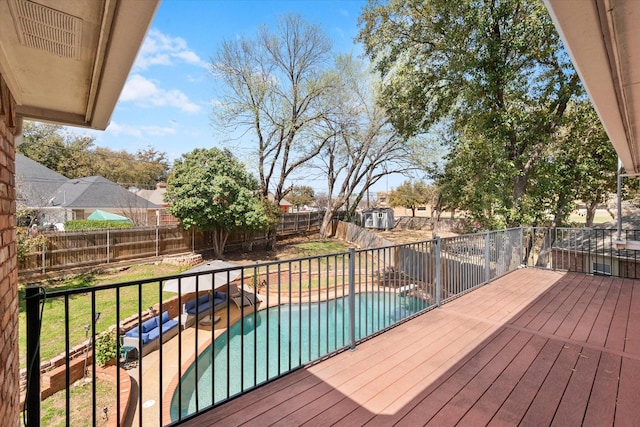 deck with a fenced in pool, a lawn, and a fenced backyard