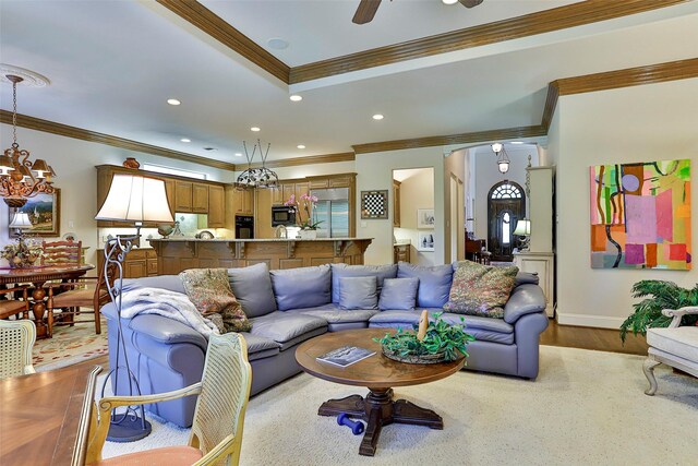 living room featuring wood finished floors, recessed lighting, baseboards, and ornamental molding