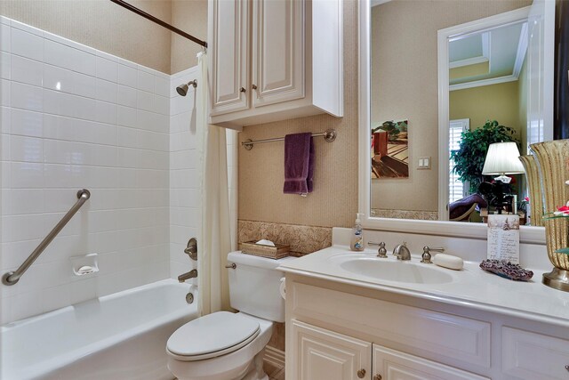 bathroom with vanity, toilet, crown molding, and shower / bath combo