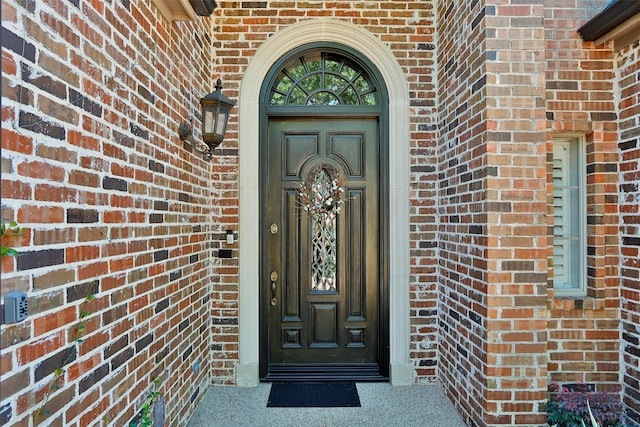 entrance to property with brick siding