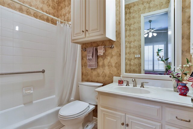 bathroom featuring toilet, shower / bath combo, vanity, and wallpapered walls