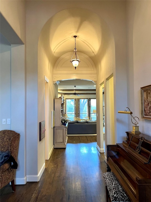 corridor featuring dark wood-style floors and baseboards