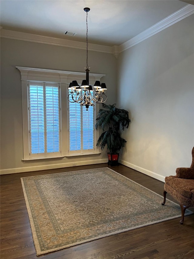 unfurnished dining area with visible vents, wood finished floors, an inviting chandelier, and ornamental molding