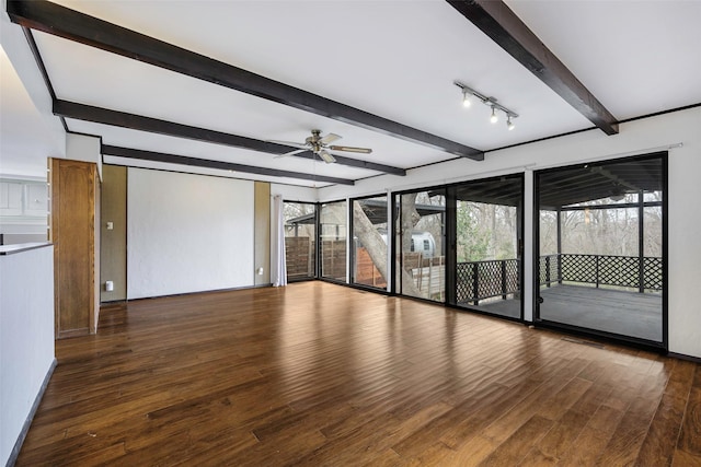 empty room featuring beamed ceiling, wood finished floors, and ceiling fan