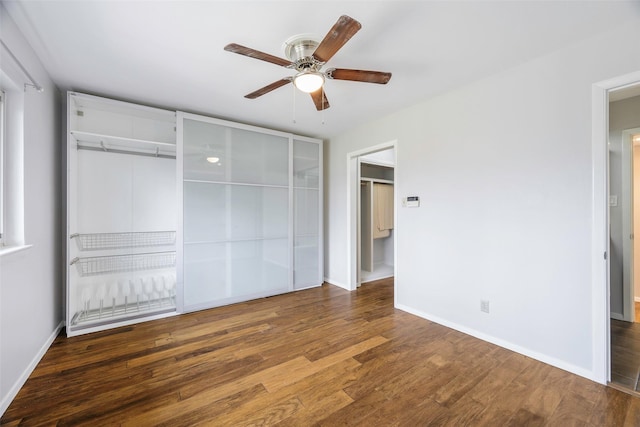 unfurnished bedroom featuring wood finished floors, baseboards, and ceiling fan