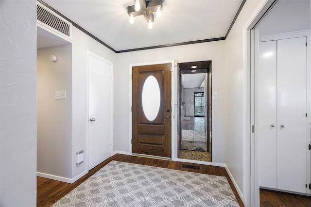 entryway featuring visible vents, baseboards, dark wood finished floors, and crown molding