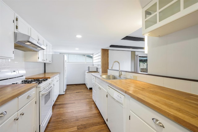 kitchen with a sink, tasteful backsplash, range hood, white appliances, and wooden counters