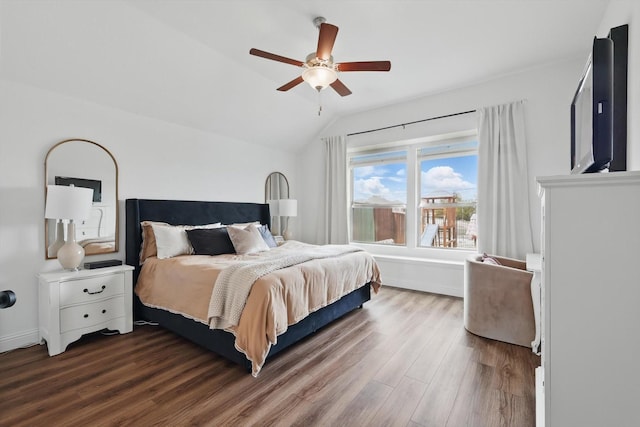 bedroom featuring baseboards, wood finished floors, a ceiling fan, and vaulted ceiling