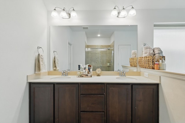 full bath featuring a shower stall, double vanity, visible vents, and a sink