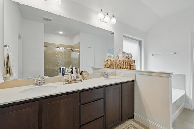 full bath featuring double vanity, visible vents, a stall shower, and a sink