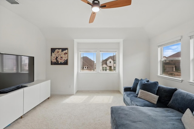 living room with vaulted ceiling, plenty of natural light, light colored carpet, and visible vents