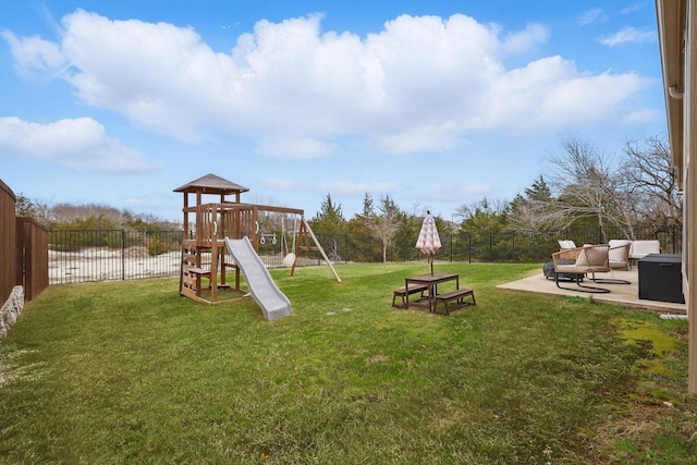 view of jungle gym with a patio area, fence, and a lawn