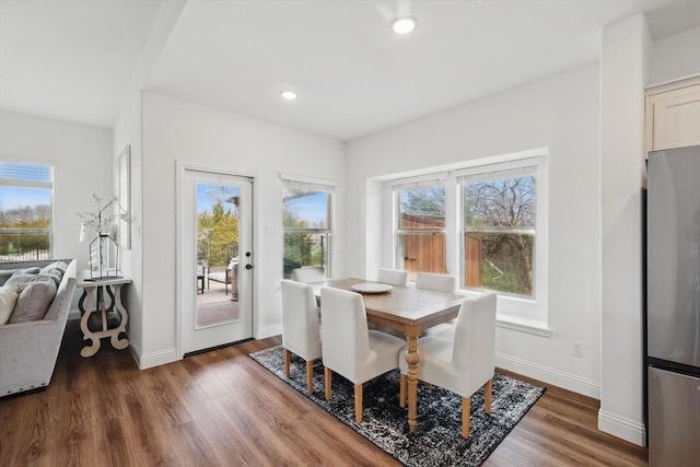 dining space featuring recessed lighting, baseboards, and wood finished floors