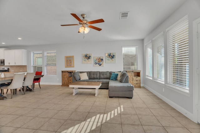 living room with visible vents, a ceiling fan, recessed lighting, light tile patterned floors, and baseboards