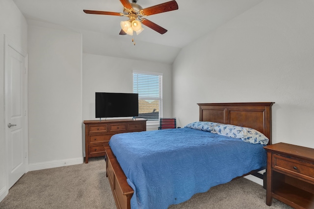 bedroom featuring baseboards, light colored carpet, a ceiling fan, and lofted ceiling