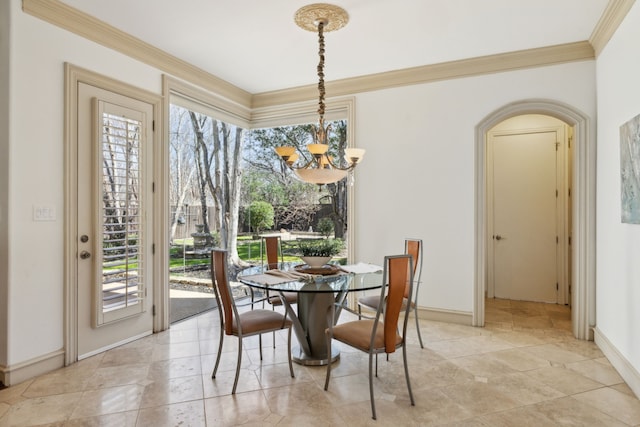 dining room featuring baseboards, a notable chandelier, and ornamental molding