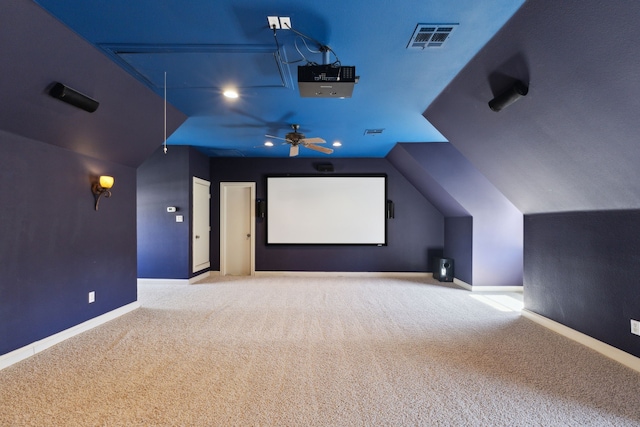 home theater with visible vents, baseboards, carpet flooring, and vaulted ceiling