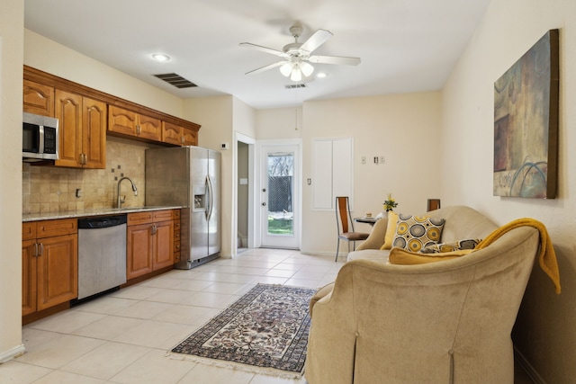 kitchen featuring light tile patterned floors, visible vents, ceiling fan, appliances with stainless steel finishes, and tasteful backsplash