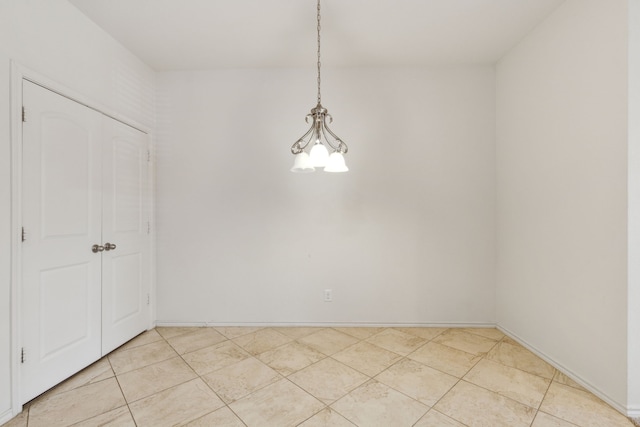 empty room featuring light tile patterned flooring and baseboards