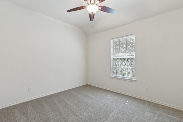 spare room featuring baseboards, a ceiling fan, lofted ceiling, and carpet floors