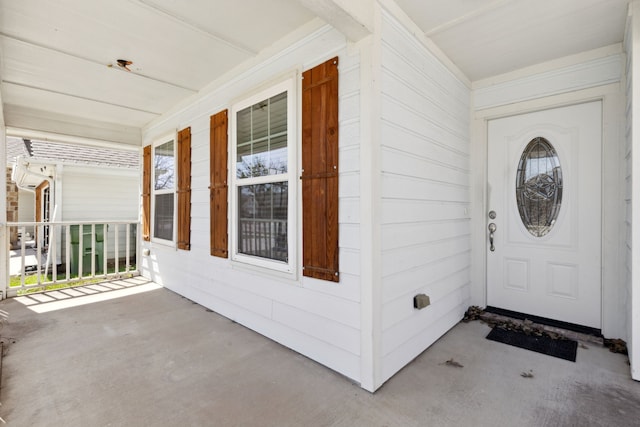 view of exterior entry with covered porch