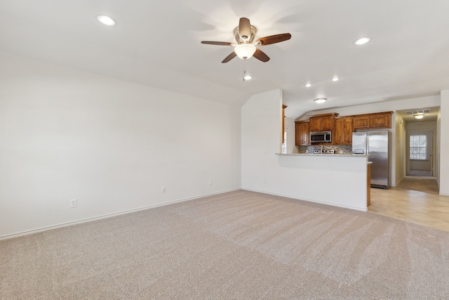 unfurnished living room with recessed lighting, light carpet, a ceiling fan, and vaulted ceiling