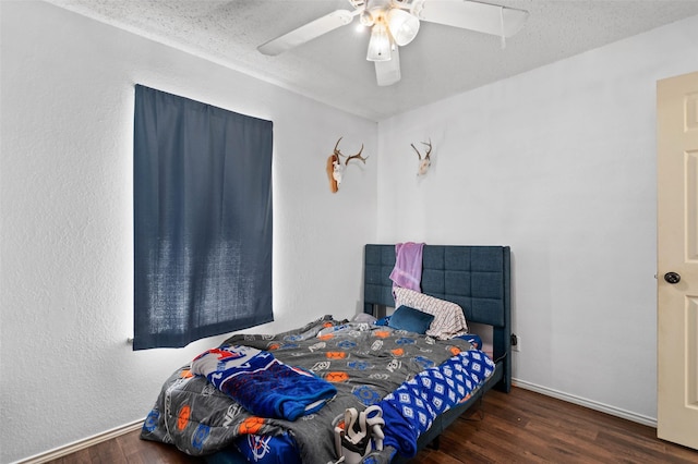 bedroom with baseboards, a textured ceiling, wood finished floors, and a ceiling fan