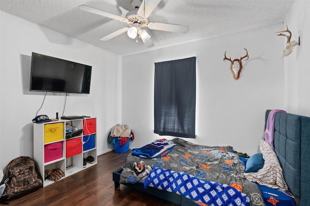 bedroom featuring a textured ceiling, ceiling fan, and wood finished floors