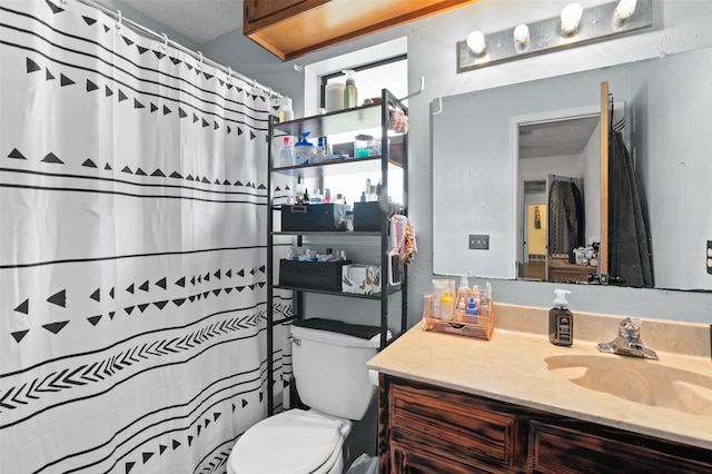 bathroom with vanity, toilet, and a shower with curtain