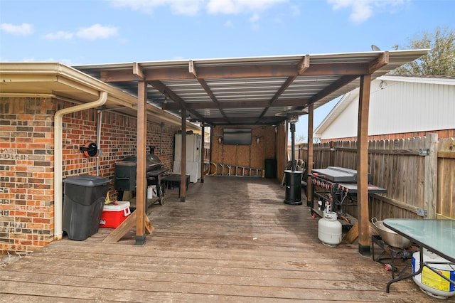 wooden terrace with area for grilling and fence