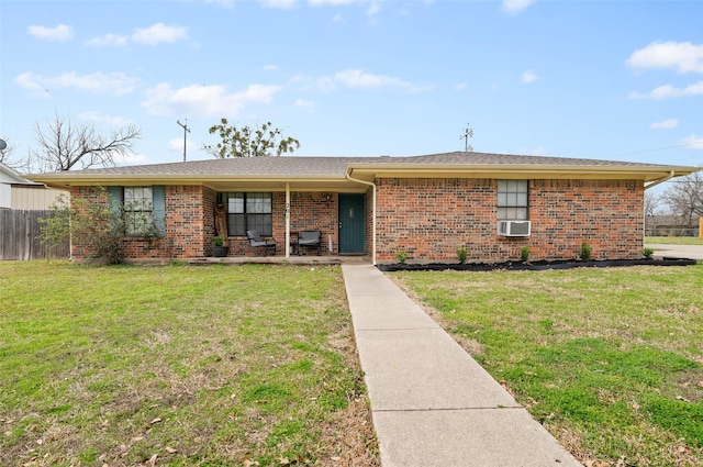 single story home featuring brick siding, a front lawn, fence, a porch, and cooling unit