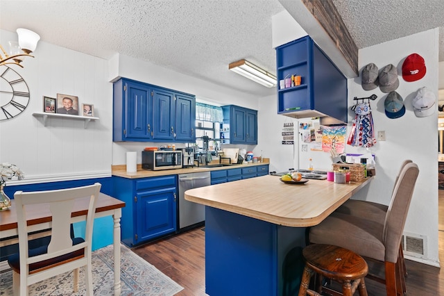 kitchen with visible vents, appliances with stainless steel finishes, blue cabinets, and open shelves