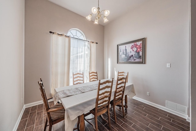 dining area with an inviting chandelier, baseboards, visible vents, and wood finish floors