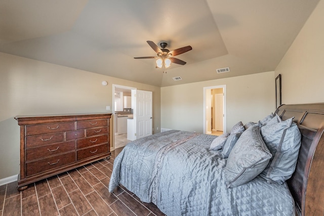 bedroom featuring visible vents, baseboards, a ceiling fan, and wood tiled floor