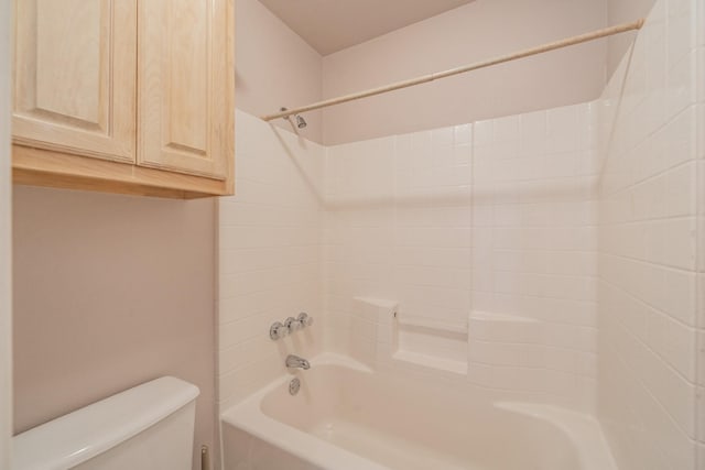 bathroom featuring shower / bath combination and toilet