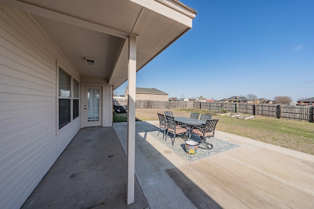 view of patio with outdoor dining area and a fenced backyard