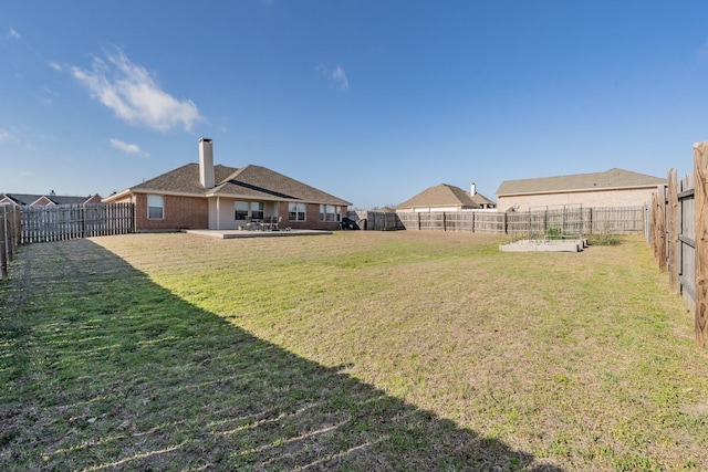 view of yard featuring a fenced backyard and a patio area